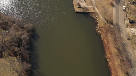 An-aerial-shot-of-a-pond-in-a-suburban-neighborhood-on-Long-Island,-NY