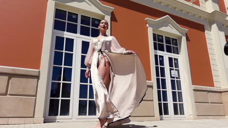 woman in beige dress in front of a building