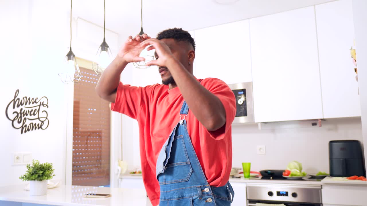 Man in overalls in a modern kitchen