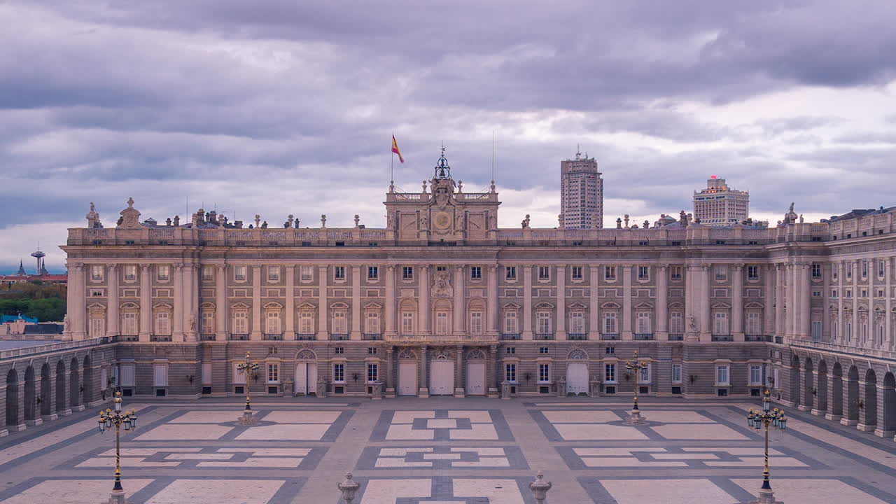 Day to night timelapse ar Royal Palace in Madrid, Spain. 
Aerial view from the balcony of the Catedral. Clouds moving during sunset and lights tourning on .