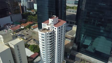 urban residential skyscraper surrounded by modern buildings in financial district of panama city