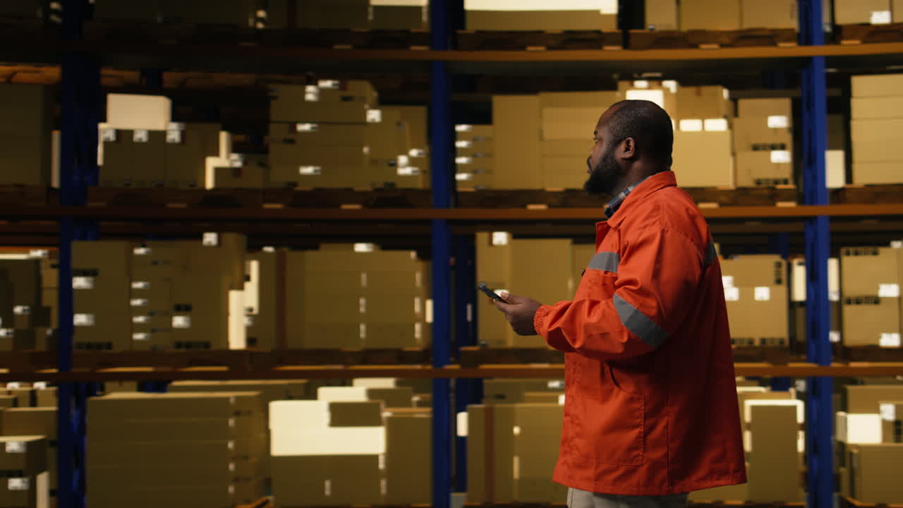 African american staff member using tablet for package inventory control