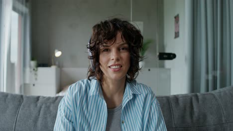 woman on couch wearing headphones