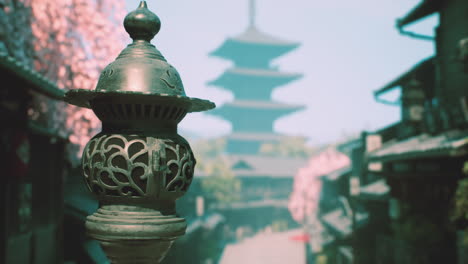 japanese lantern and temple in a cherry blossom-filled town