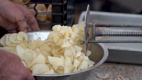 Potatoes-curling-out-of-a-cutter-making-tornado-curly-fries