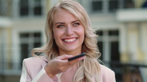 portrait woman using voice message at street. woman using phone outdoor