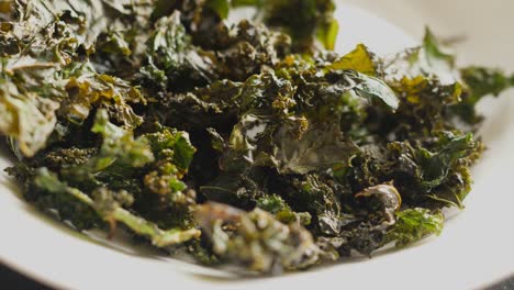 baked curly kale chips crispy dry dried leaves rotating turning round