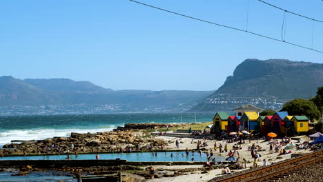 Caluroso-Día-De-Verano-Con-Gente-Nadando-En-La-Piscina-De-Marea-De-La-Playa-De-St-James,-Muizenberg