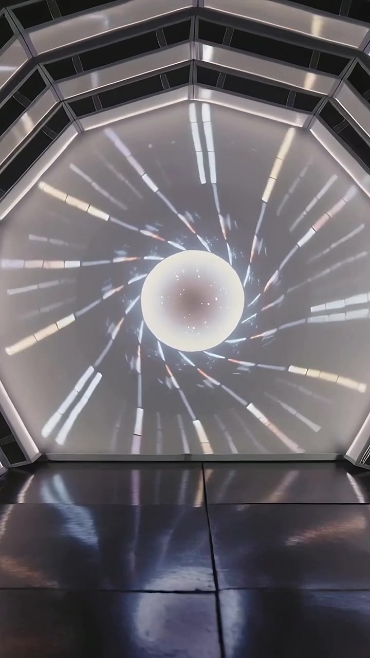 Vertical video: On start octagon showing orb lines rotating on screen in gallery floor reflecting