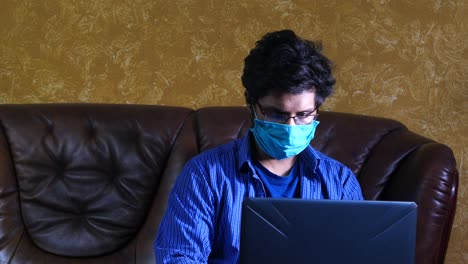 young man working from home on laptop