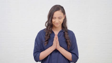 indian girl doing namaste and greeting