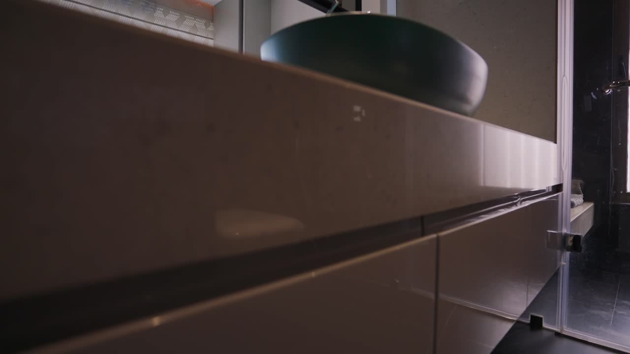 lavabo minimalista y diseño de baño interior de color neutral con vistas al dormitorio