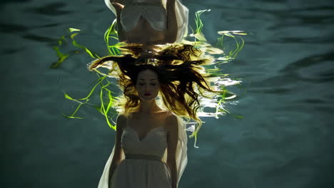 beautiful woman underwater in flowing dress