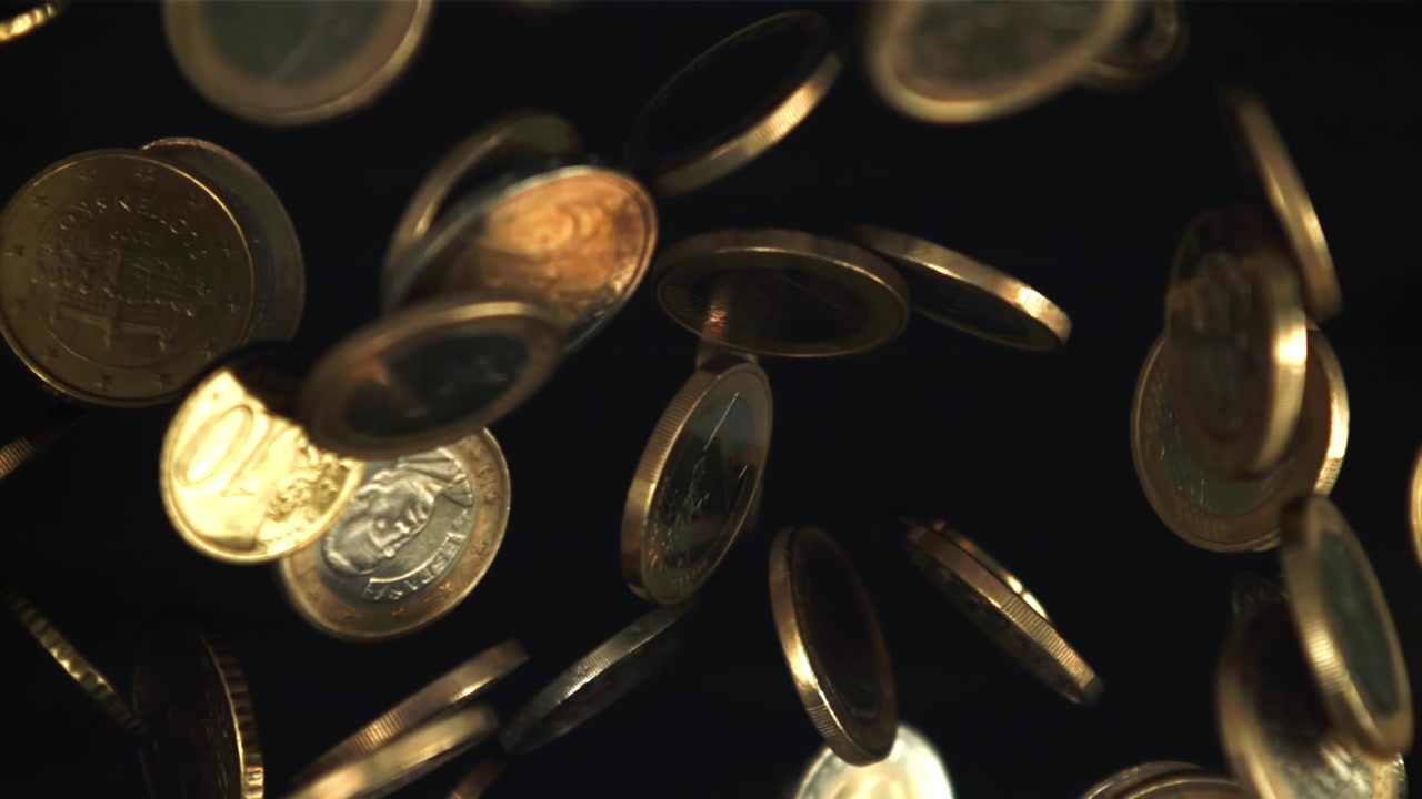 Euro Coins Falling in Slow Motion Against a Dark Background