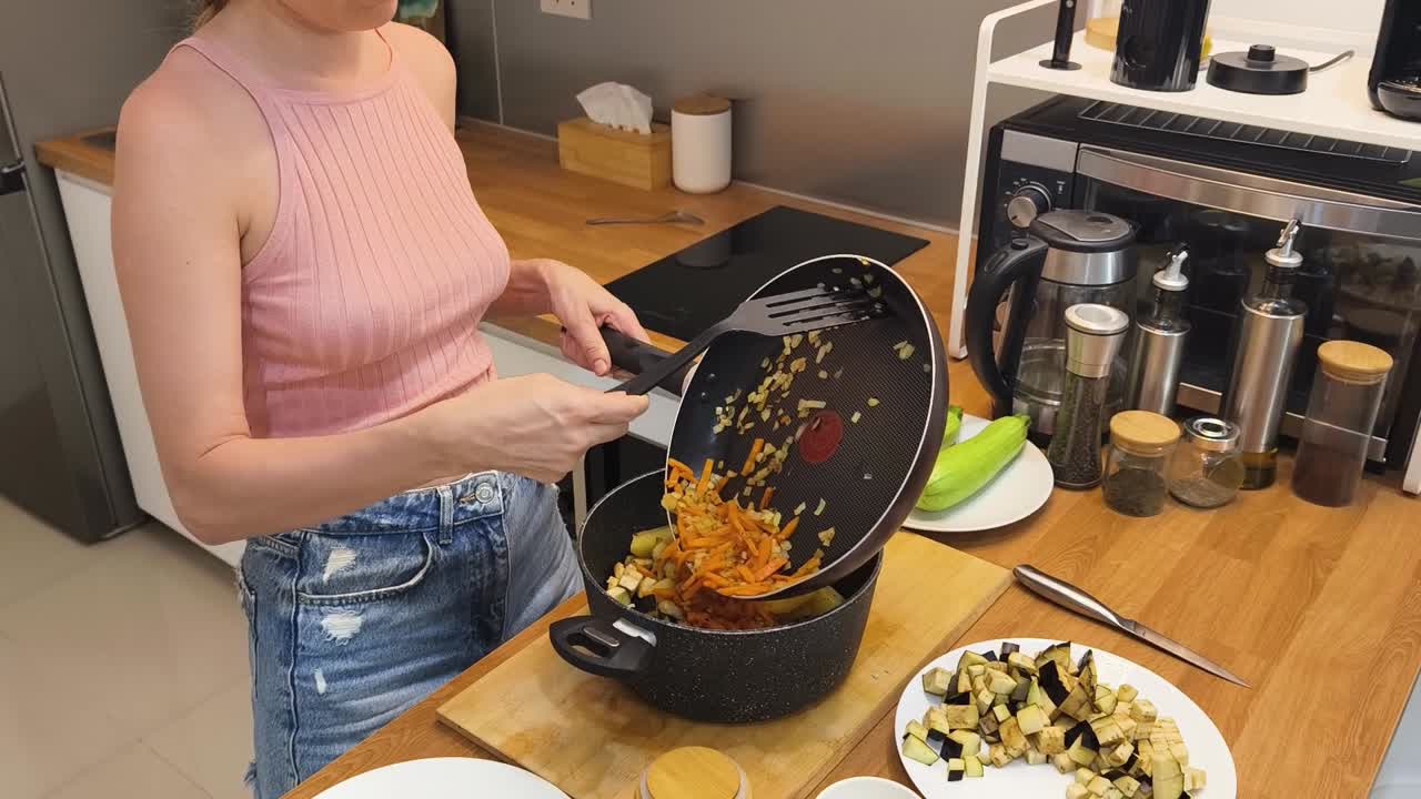 Woman cooking vegetables in the kitchen