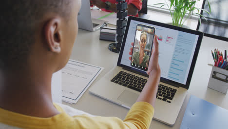 African-american-businesswoman-using-smartphone-for-video-call-with-caucasian-business-colleague