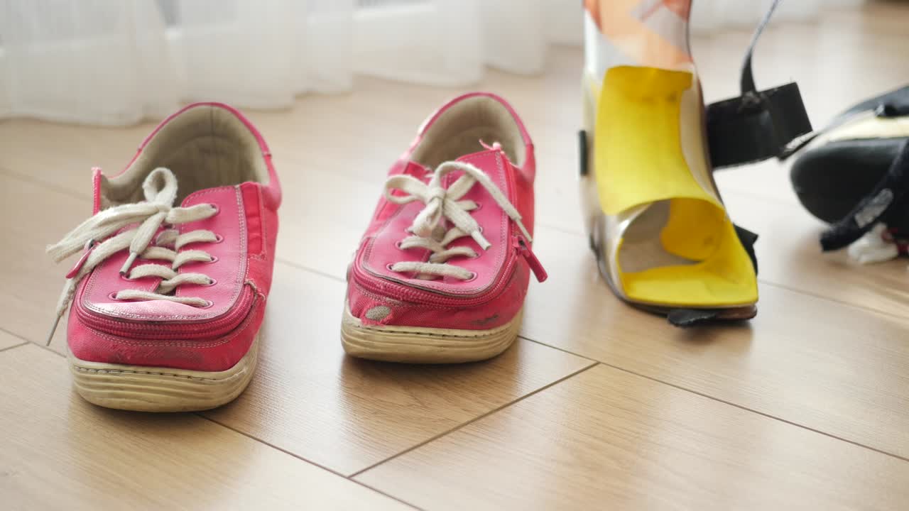 Orthopedic shoes and foot brace on wooden floor