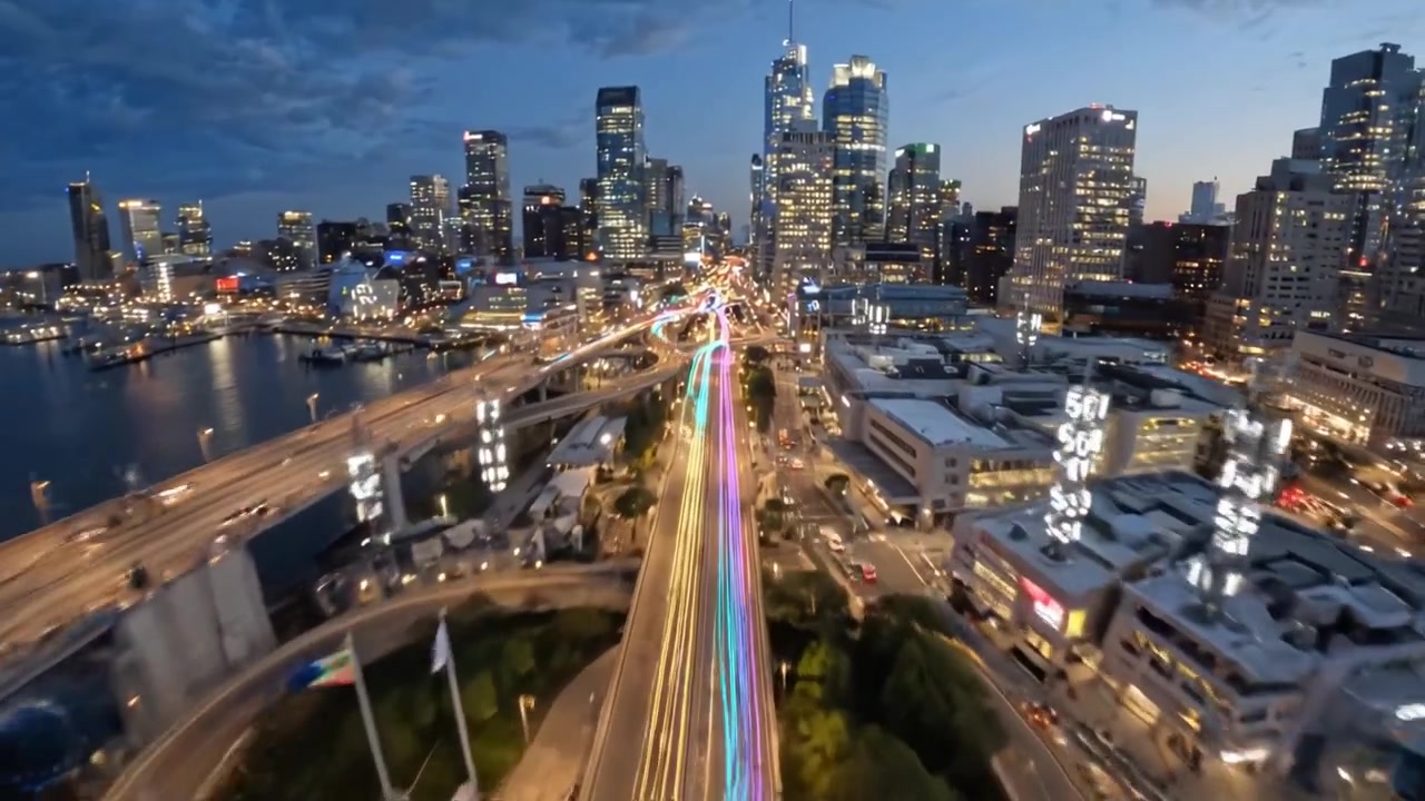 Breathtaking Night Views of a City Skyline with Vibrant Lights Reflecting on Water Creating a Stunning Urban Scene Captured in Two Frames from a Video