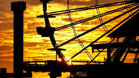 silhouette of ferris wheel at sunset