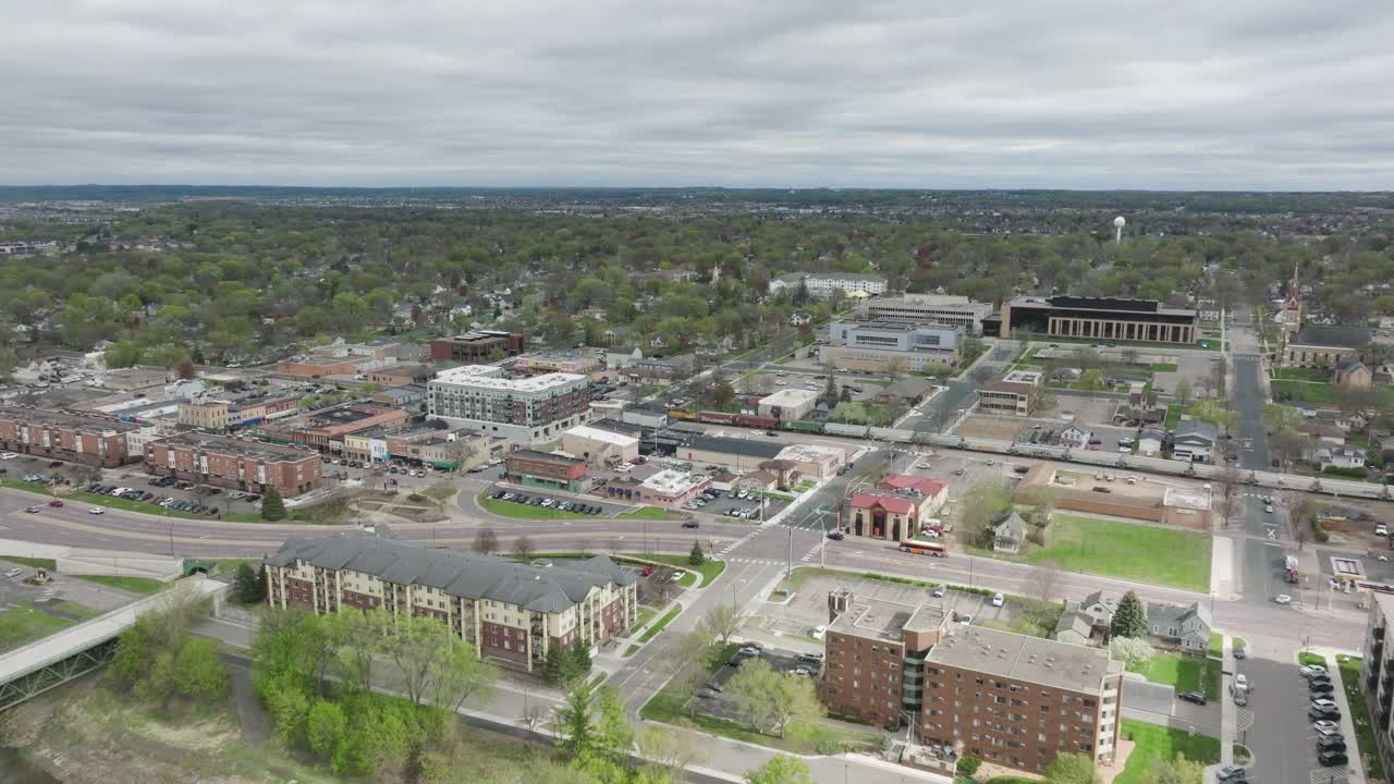 Minnesota River In The Foreground Of Downtown Shakopee In Minnesota, USA. - aerial shot
