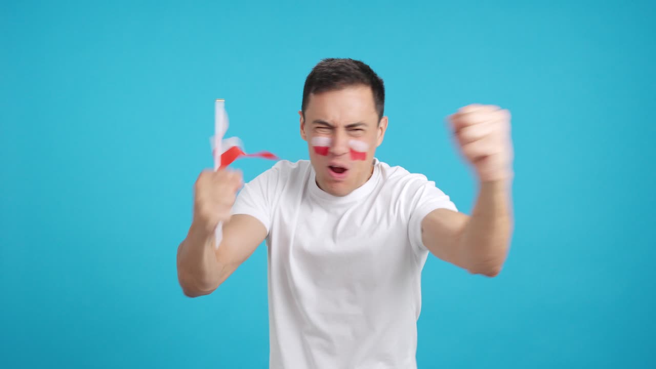 Man cheering for Poland screaming and waving a national flag