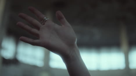 close-up of a hand with a ring gesturing