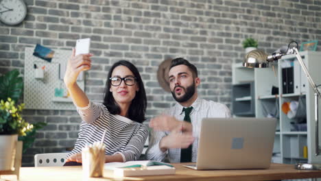 business colleagues taking a selfie in the office