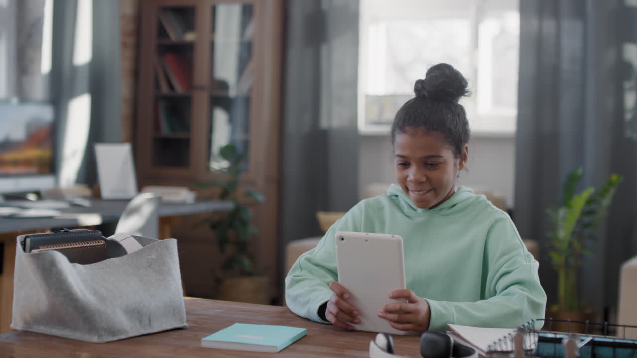 Afro Girl Using Tablet At Home