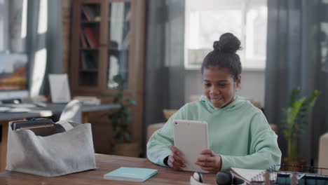 afro girl using tablet at home