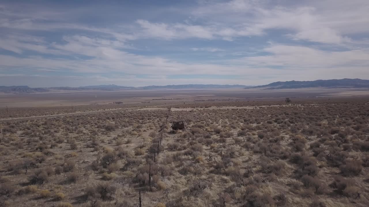 Vast Desert Landscape with Abandoned Vehicle