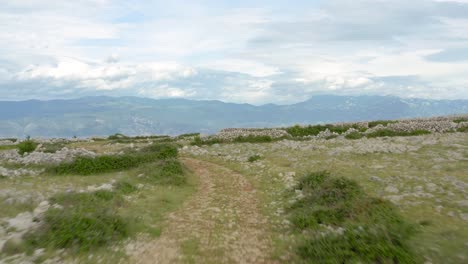 Low-aerial-flyover-over-the-moon-plateau-on-Krk-Island,-Croatia-on-a-cloudy-day