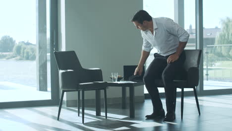 business man waiting for business meeting. handsome man sitting on chair.