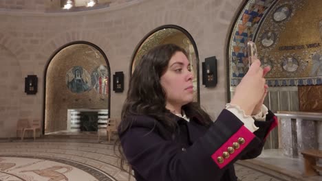 woman tourist in awe of church interior, dormition abbey on mount zion. slow motion.