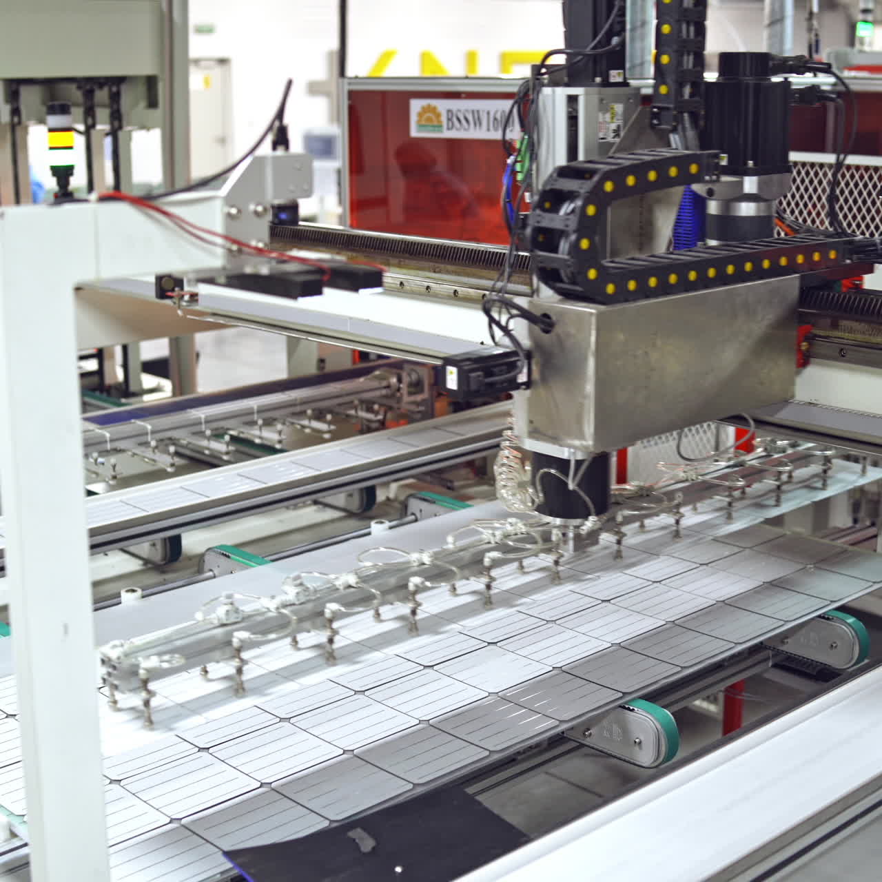 Footage of a working factory mechanism of solar cells distribution. Automated solar energy production. Contemporary factory for producing solar panels.