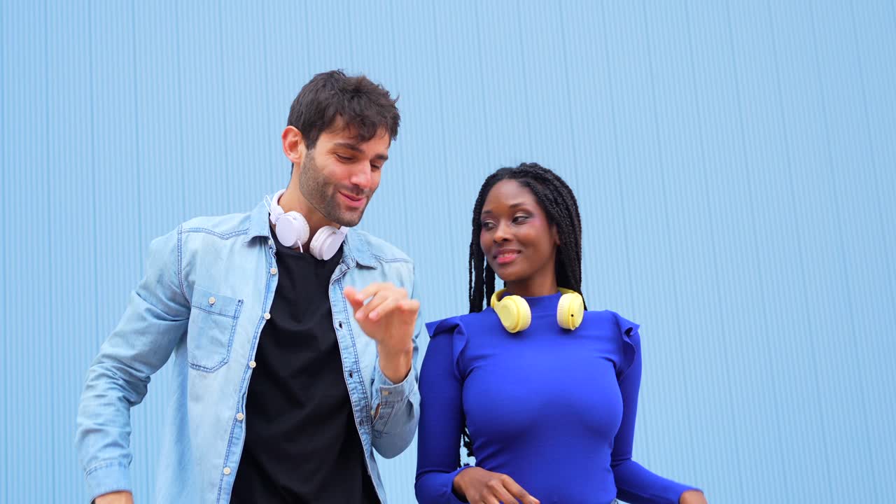 People dancing with headphones on a blue background