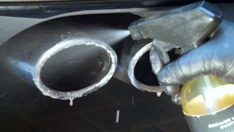 spraying exhausts with chemical cleaner