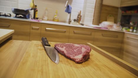 slamming a4 wagyu beef steak on chopping board with kitchen knife in the kitchen