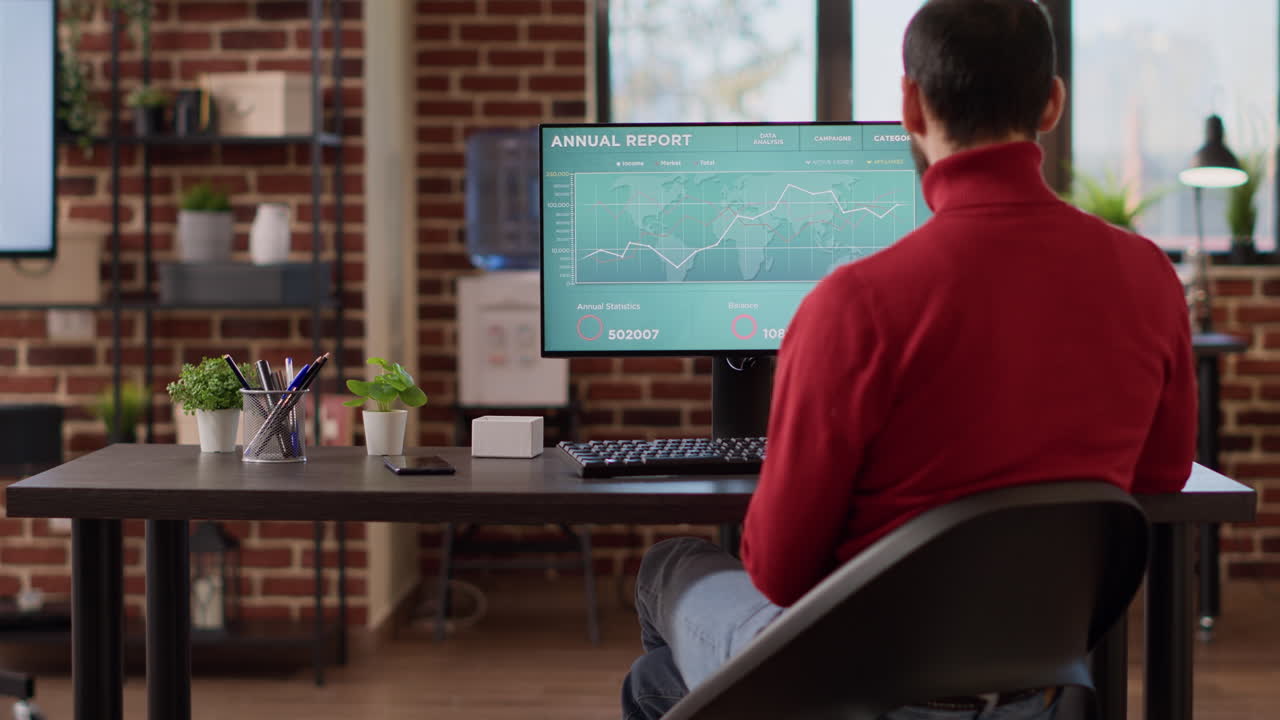 Project manager looking at computer with forex echange charts