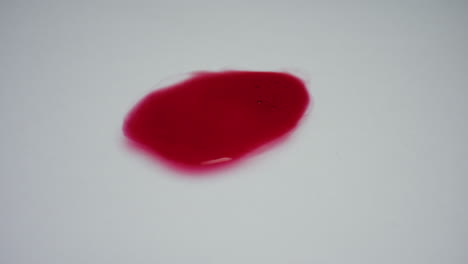 Red-liquid-on-white-background.-Closeup-blood-drop-with-bubbles