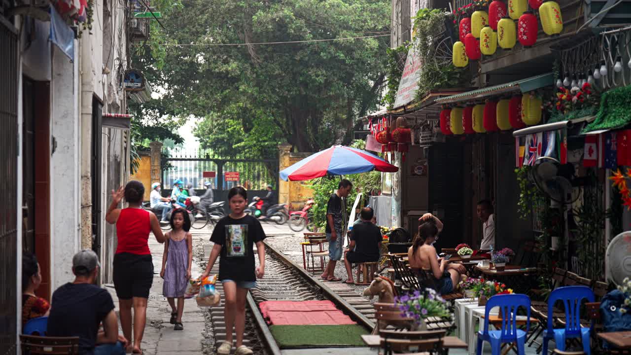 Hanoi train street with cafes and shops, local residents, Static shot