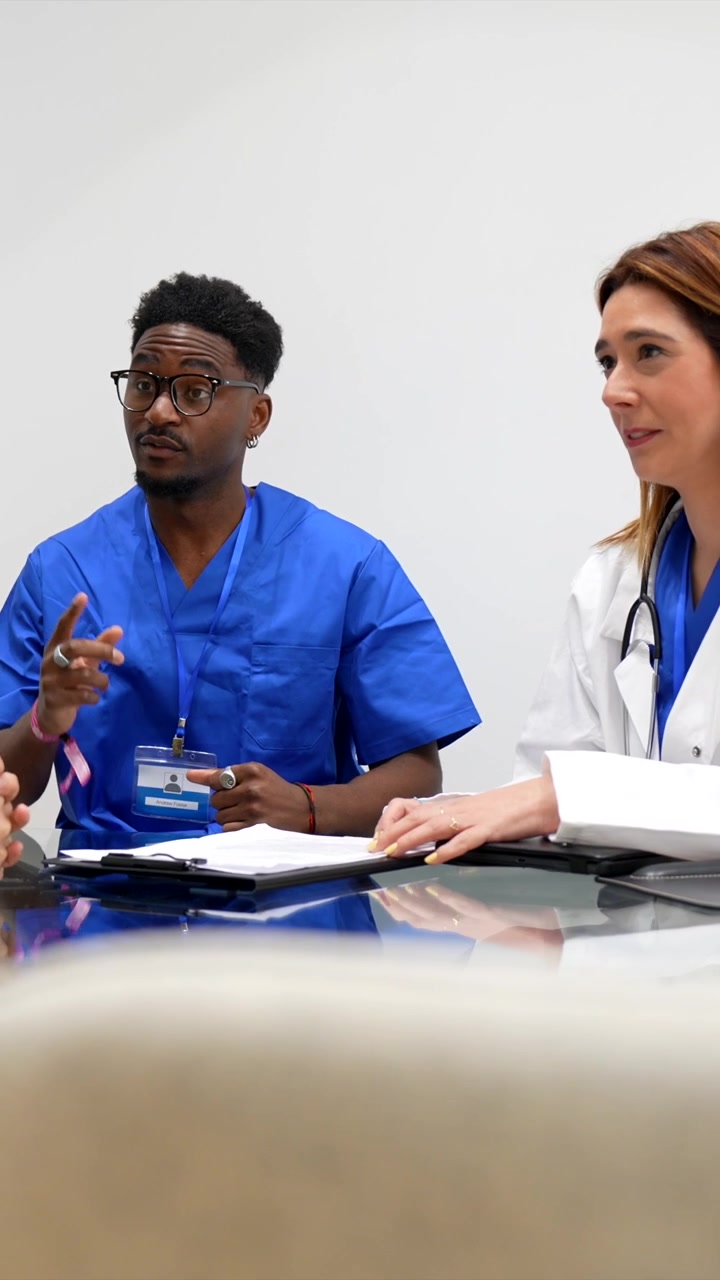 Professionisti medici che discutono le cartelle cliniche dei pazienti in una riunione in ospedale
