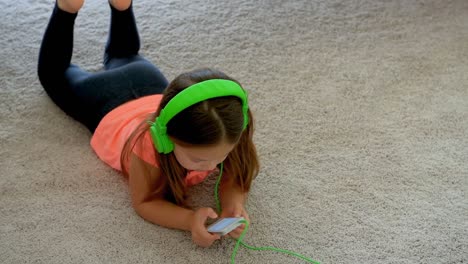 Girl-using-mobile-phone-on-floor-at-home-4k