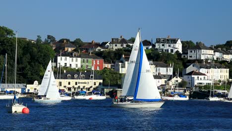 sailboats sailing down the river tamar with a panning shot between devon and cornwall from the saltash town