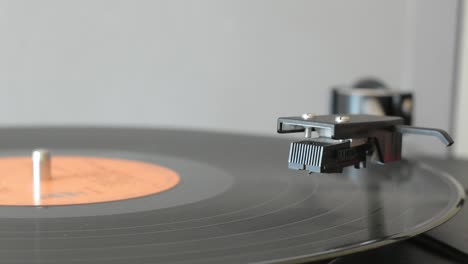 vinyl record player spinning on vintage vinyl turntable player and being stopped