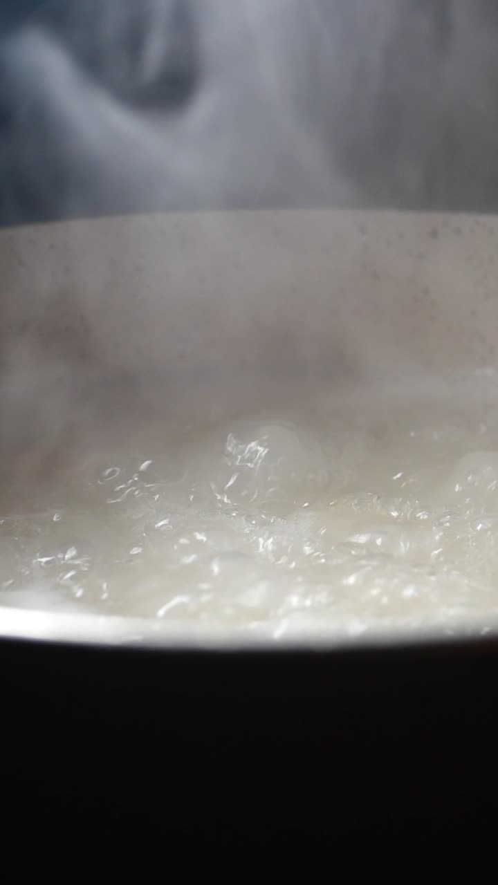 Close Up of Boiling Water with Steam in a Pot