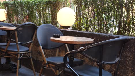 empty cafe tables and chairs on a terrace