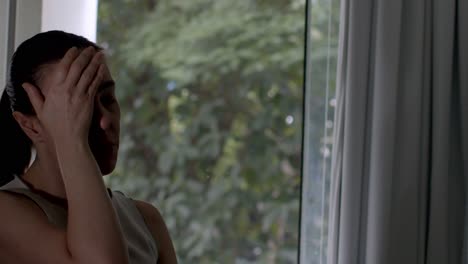 she frowns at her thoughts, fatigued and feeling pressure
