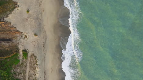 rough ocean with beach nature background overhead vertical relaxing