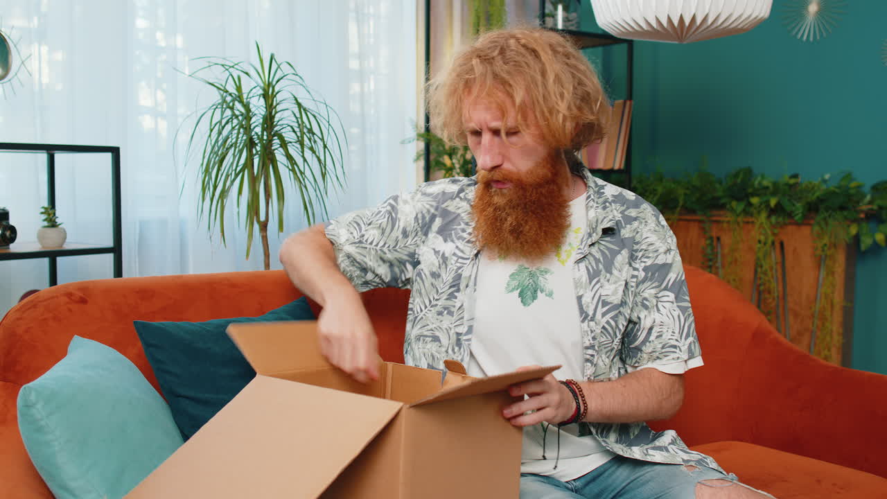 Angry dissatisfied shopper caucasian man unpacking parcel feeling upset confused wrong delivery