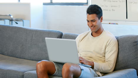 Mann-Mit-Einem-Laptop-Auf-Der-Couch-Sitzend